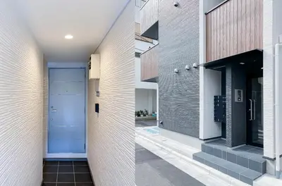 a hallway of a house with a blue door at japan house shinkoiwa in Tokyo
