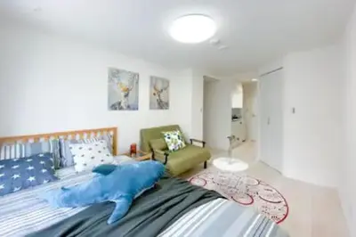a bedroom with a large bed and a couch at japan house shinkoiwa in Tokyo