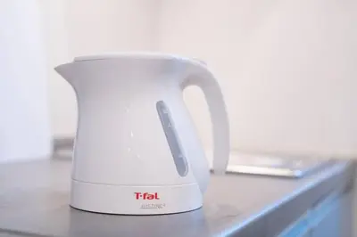 a white tea kettle sitting on a counter at \u6d45\u8349\u30b6 \u30a2\u30d1\u30fc\u30c8\u30e1\u30f3\u30c8 Asakusa The Apartment in Tokyo
