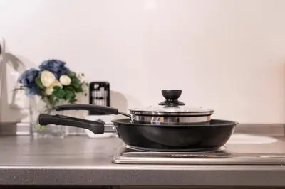 a pan sitting on top of a kitchen stove at \u6d45\u8349\u30b6 \u30a2\u30d1\u30fc\u30c8\u30e1\u30f3\u30c8 Asakusa The Apartment in Tokyo