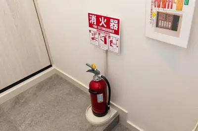 a fire extinguisher in a corner of a room at Villa Roppongi in Tokyo