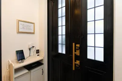 a black door in a room with a desk with a computer at Villa Roppongi in Tokyo