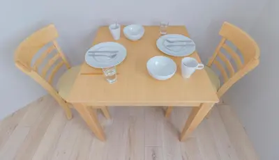 a wooden table with plates and dishes on it at japan house edogawabashi in Tokyo