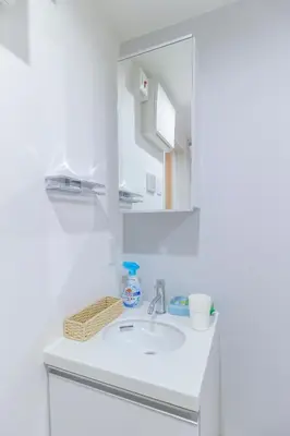 a white bathroom with a sink and a mirror at japan house edogawabashi in Tokyo