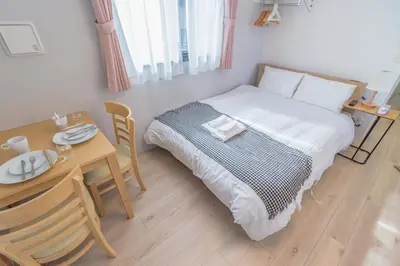 a small bedroom with a bed and a table at japan house edogawabashi in Tokyo