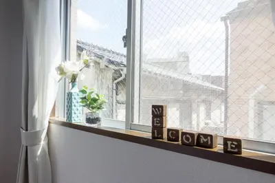 a window with a view of a building at nestay apartment tokyo ikebukuro in Tokyo