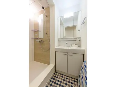 a bathroom with a shower and a sink and a mirror at rakuna Inn Dou-sasazuka - Vacation STAY 47231v in Tokyo