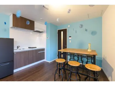 a kitchen with a counter and stools in a room at rakuna Inn Dou-sasazuka - Vacation STAY 47231v in Tokyo