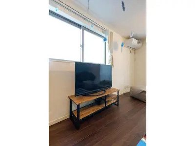 a living room with a large flat screen tv on a table at rakuna Inn Dou-sasazuka - Vacation STAY 47231v in Tokyo