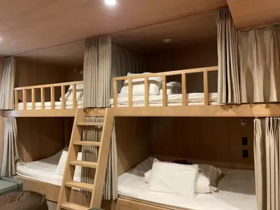 two bunk beds in a room with a ladder at THE BONDS HOTEL TOKYO - Vacation STAY 48446v in Tokyo