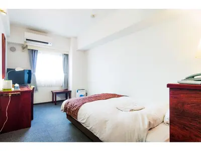 a bedroom with a bed and a dresser and a window at Sky Heart Hotel Koiwa - Vacation STAY 49085v in Tokyo