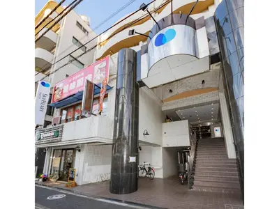 a building with a staircase in the middle of a street at Sky Heart Hotel Koiwa - Vacation STAY 49094v in Tokyo
