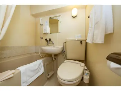 a small bathroom with a toilet and a sink at Sky Heart Hotel Koiwa - Vacation STAY 49094v in Tokyo