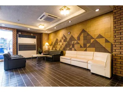a living room with a couch and two chairs at Sky Heart Hotel Koiwa - Vacation STAY 49101v in Tokyo