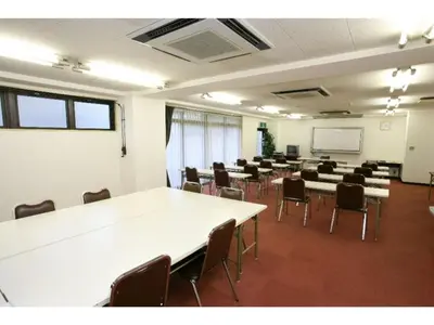 a room with tables and chairs in a classroom at Sky Heart Hotel Koiwa - Vacation STAY 49101v in Tokyo