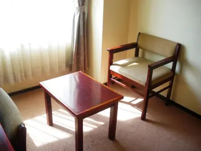 a living room with a chair and a coffee table at Sky Heart Hotel Koiwa - Vacation STAY 49101v in Tokyo