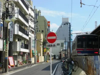 a red stop sign on a city street with a bus at Sky Heart Hotel Koiwa - Vacation STAY 49104v in Tokyo
