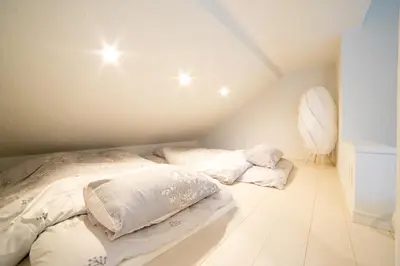 a bedroom with two beds with pillows on the floor at Skytree view Oshiage in Tokyo