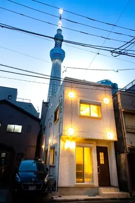 a building with a tv tower in the background at Skytree view Oshiage in Tokyo