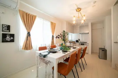 a kitchen and dining room with a white table and chairs at Skytree view Oshiage in Tokyo