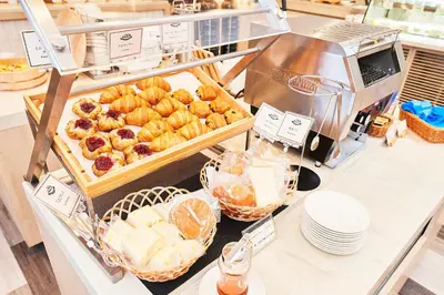 a bakery counter with pastries and breads on it at Keisei Richmond Hotel Tokyo Kinshicho in Tokyo