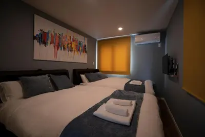 a bedroom with two beds with towels on them at \u8cb8\u5207\u4e00\u8ed2\u5bb6 \u6771\u4eac\u30f4\u30a3\u30e9 \u30ea\u30d0\u30fc\u30b5\u30a4\u30c9\u5e73\u4e95 in Tokyo