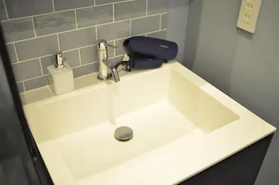 a white sink with a soap dispenser on top of it at \u8cb8\u5207\u4e00\u8ed2\u5bb6 \u6771\u4eac\u30f4\u30a3\u30e9 \u30ea\u30d0\u30fc\u30b5\u30a4\u30c9\u5e73\u4e95 in Tokyo
