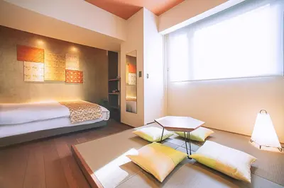 a bedroom with a bed and a table and a window at Asakusa Kaede \u6d45\u8349\u6953 in Tokyo