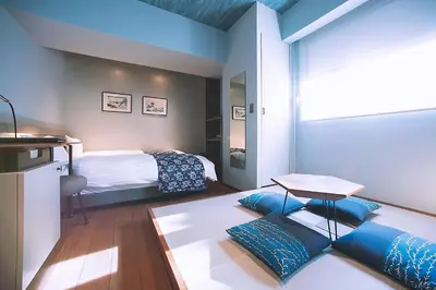 a bedroom with a bed and a table in a room at Asakusa Kaede \u6d45\u8349\u6953 in Tokyo