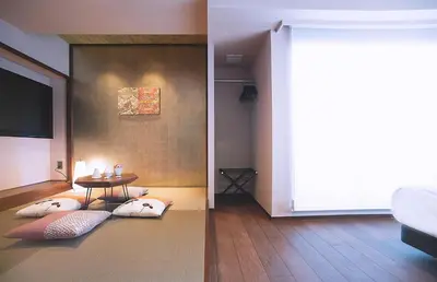 a living room with a table with pillows on the floor at Asakusa Kaede \u6d45\u8349\u6953 in Tokyo