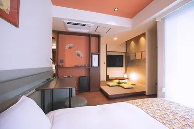 a bedroom with a bed and a desk in a room at Asakusa Kaede \u6d45\u8349\u6953 in Tokyo