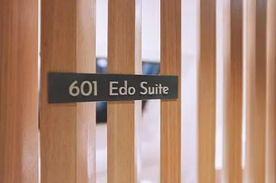 a sign that says echo suite on a wooden fence at Asakusa Kaede \u6d45\u8349\u6953 in Tokyo