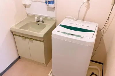 a small bathroom with a sink and a washing machine at Esperanza 303\u53f7\u5ba4 in Tokyo
