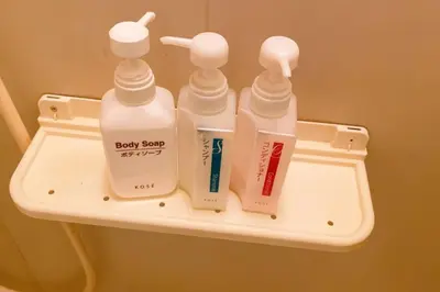 a shelf with four bottles of baby soap and toothpaste at Esperanza 303\u53f7\u5ba4 in Tokyo