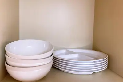 a stack of plates and bowls sitting in a cabinet at Esperanza 303\u53f7\u5ba4 in Tokyo