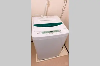 a fax machine sitting in a corner next to a wall at Esperanza 303\u53f7\u5ba4 in Tokyo