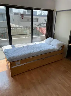 a bed in a room with a large window at Esperanza 303\u53f7\u5ba4 in Tokyo