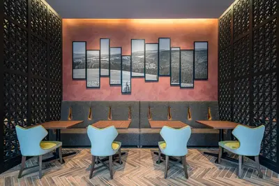 a restaurant with tables and chairs and a painting at Hotel GrandBach Tokyo Ginza in Tokyo