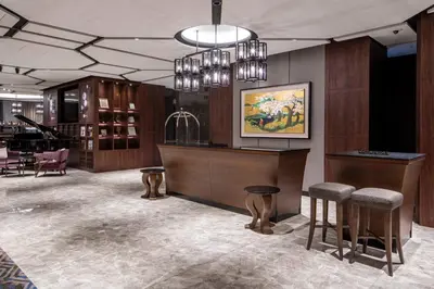 a restaurant with a bar with stools in a room at Hotel GrandBach Tokyo Ginza in Tokyo