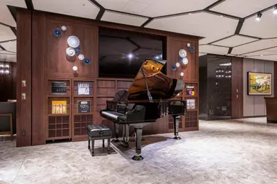 a grand piano in a room with plates on the wall at Hotel GrandBach Tokyo Ginza in Tokyo