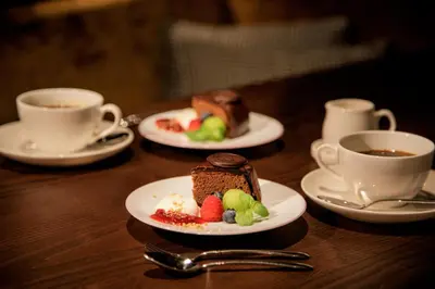 a table with two plates of food and cups of coffee at Hotel GrandBach Tokyo Ginza in Tokyo