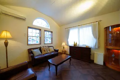 a living room with a couch and a table at Shinjuku Sakaue House in Tokyo