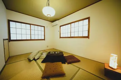 a room with a table in the middle of it at Shinjuku Sakaue House in Tokyo