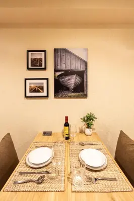 a table with two plates and a bottle of wine at Ostay Ikebukuro Dairaku Hotel Apartment in Tokyo