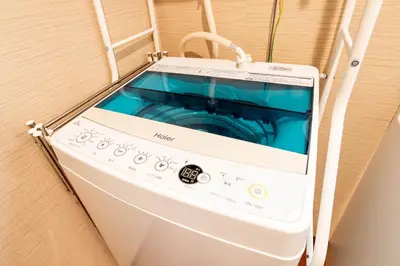 a washing machine is sitting on a shelf at Ostay Ikebukuro Dairaku Hotel Apartment in Tokyo