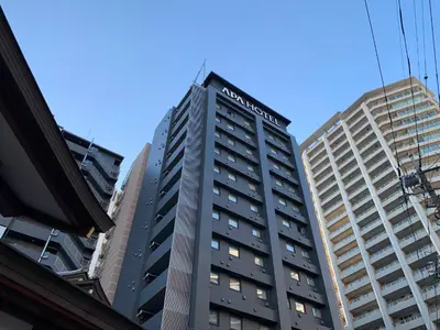 a tall building with windows in a city at APA Hotel Keikyu Kamata Ekimae Nishi in Tokyo