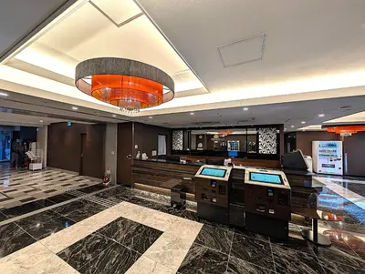 a lobby with a hair salon with a chandelier at APA Hotel Keikyu Kamata Ekimae Nishi in Tokyo