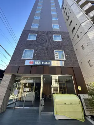 a large building with a large truck in front of it at ELE Hotel \u6771\u4e0a\u91ce in Tokyo