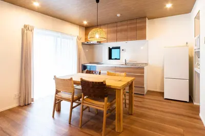 a kitchen and dining room with a wooden table and chairs at GIVE Shibuya Honmachi in Tokyo