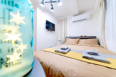 a bedroom with a bed with two towels on it at nestay inn tokyo ryogoku in Tokyo